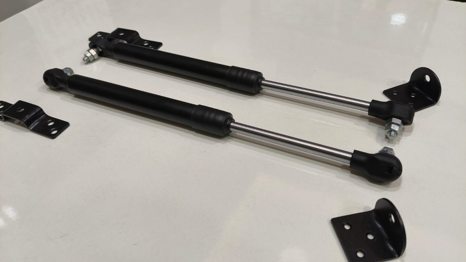 Pair of matched gas springs with ball-socket end fittings